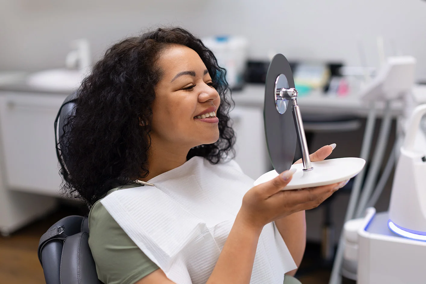 A patient checking her restored smile at Anamosa Dental Associates