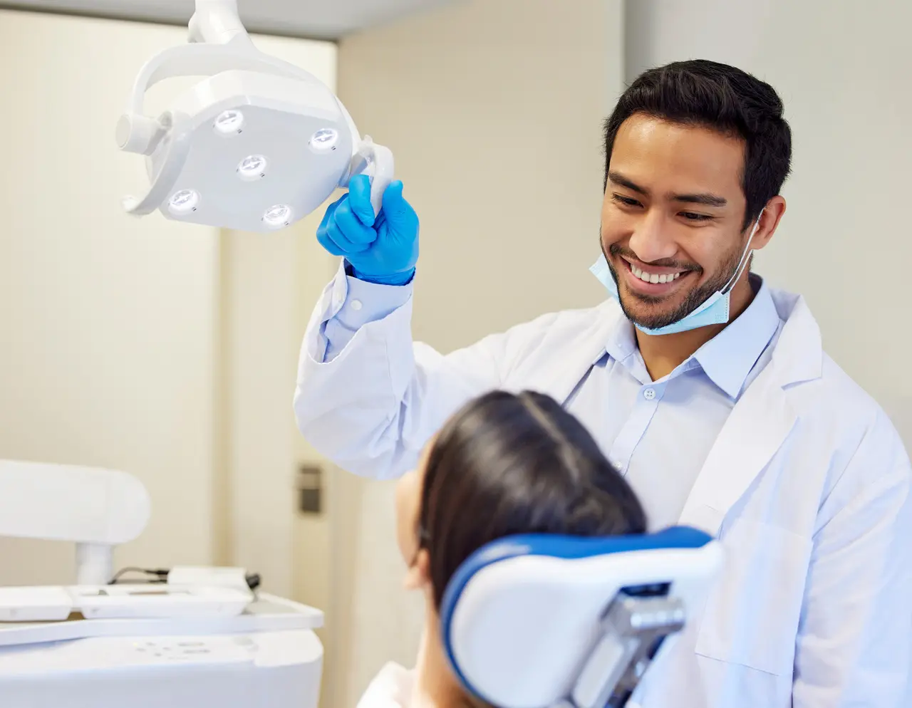 A dentist showing a young patient a model during a checkup