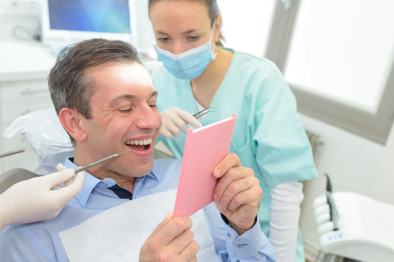 A patient matching a crown shade with his dentist