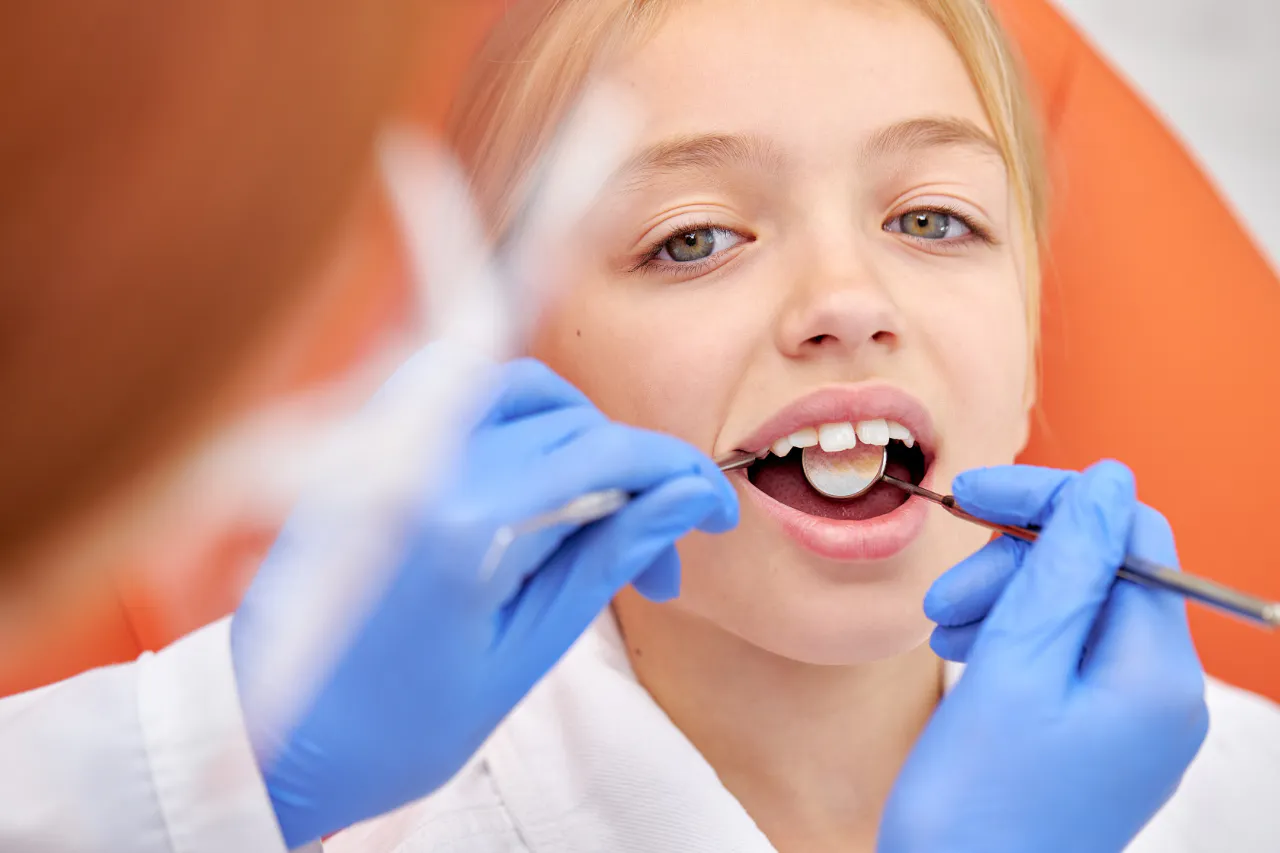 A young patient having her back teeth checked before sealants