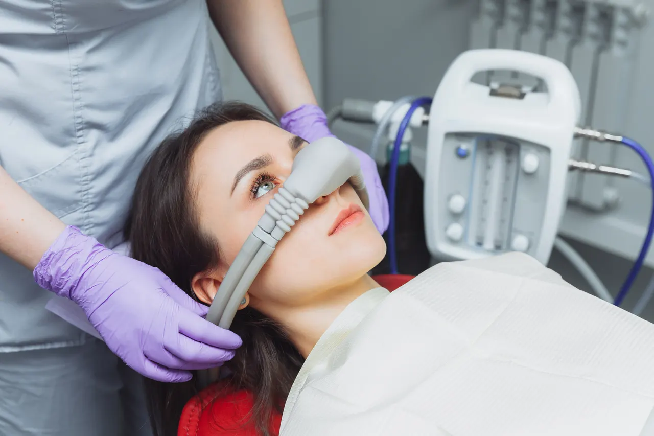 A patient wearing a sedation mask during treatment