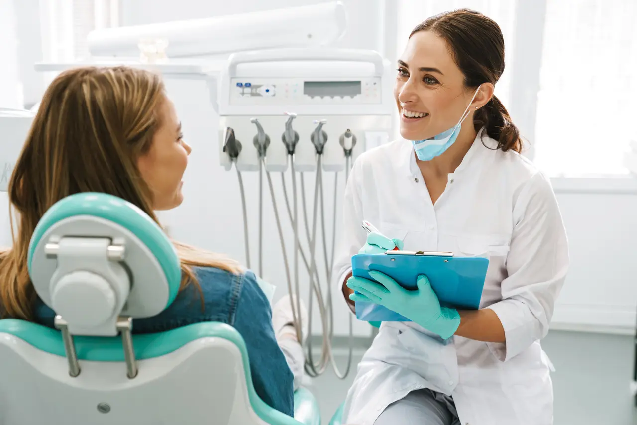 A clinician discussing treatment options with a seated patient